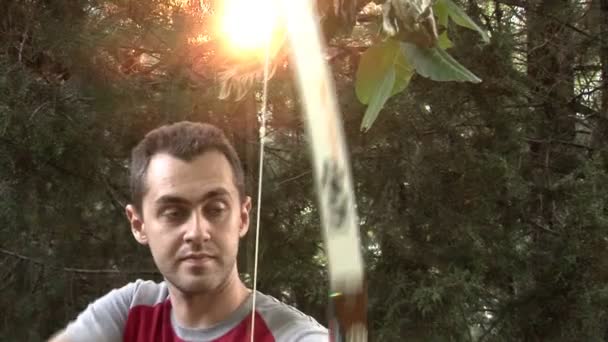 Young man practicing archery in nature — Stock videók