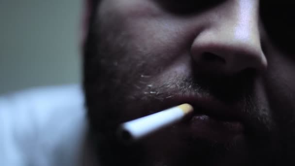 SUPER 35MM CAMERA - Bearded man lighting and smoking a cigarette — Stock Video