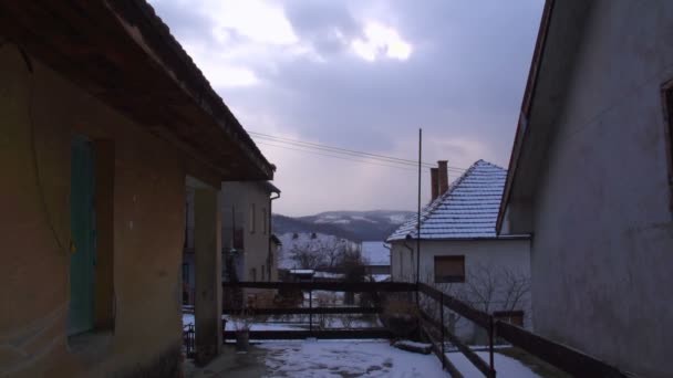 Sony FS100 - Cold winter day - clouds over village houses - timelapse graded grey and dull — стокове відео