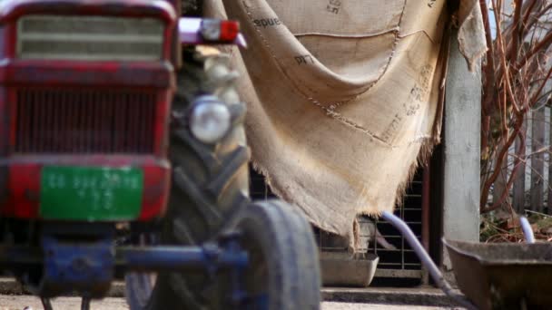 Σούπερ 35 χιλιοστά φωτογραφική μηχανή - παλιό τρακτέρ μπροστά από ένα σπίτι χοίρος, χοιροστάσιο — Αρχείο Βίντεο