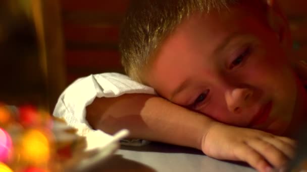 Niño joven y soñoliento en la mesa del restaurante — Vídeos de Stock