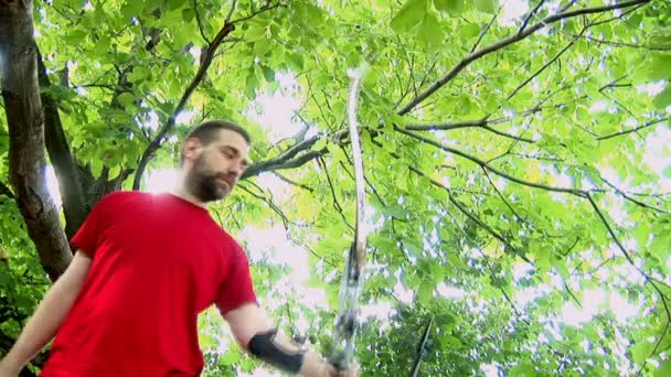 Young man shooting with bow and arrows — Stock Video