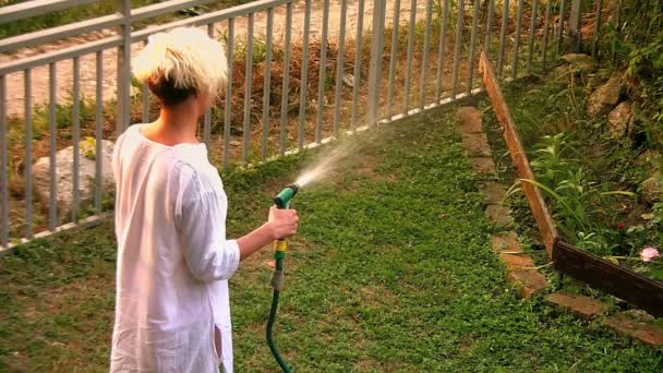 Young woman watering garden — Stock Video