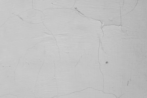 Üzerinde çatlaklar olan beyaz ve gri bir duvar. Beton ve çimento dokusu. Sıva. Grunge 'un geçmişi. Eski beton yüzey.