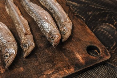 Koyu ahşap bir masada kurutulmuş balık, bira atıştırmalıkları..