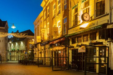 Den Bosch, The Netherlands - December 21, 2021: Pubs and restaurants with christmas decoration in Den Bosch, The Netherlands