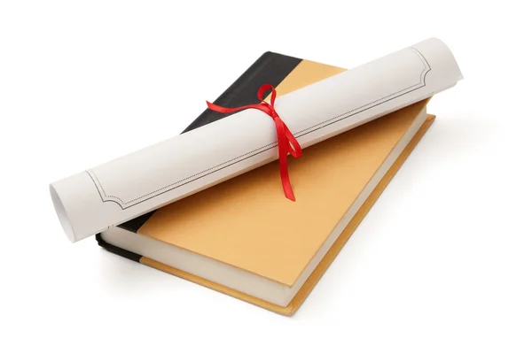 Diploma over book — Stock Photo, Image
