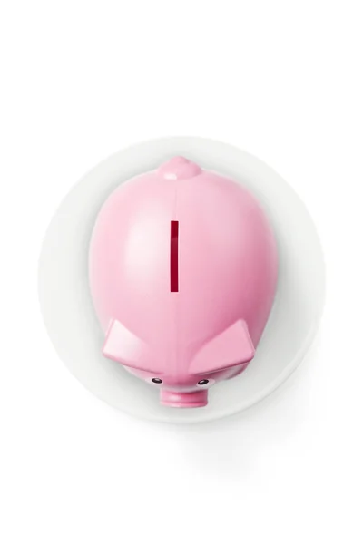 Piggy bank on plate — Stock Photo, Image