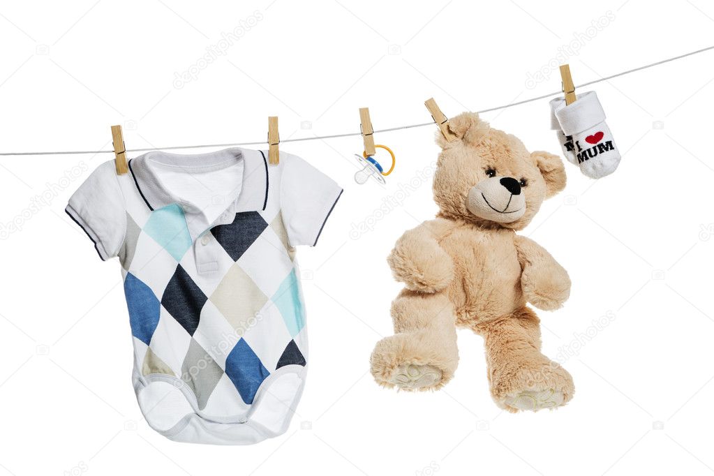 Baby clothes and teddy bear hanging on the clothesline