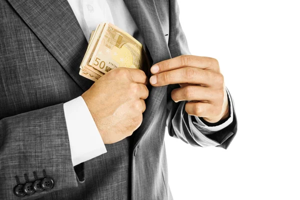 A businessman in a suit putting money in his pocket — Stock Photo, Image