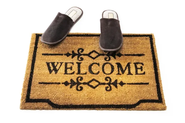 Welcome mat and slippers — Stock Photo, Image