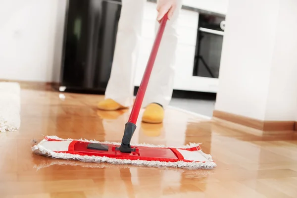 Woman mopping the hardwood floor — Stock Photo, Image