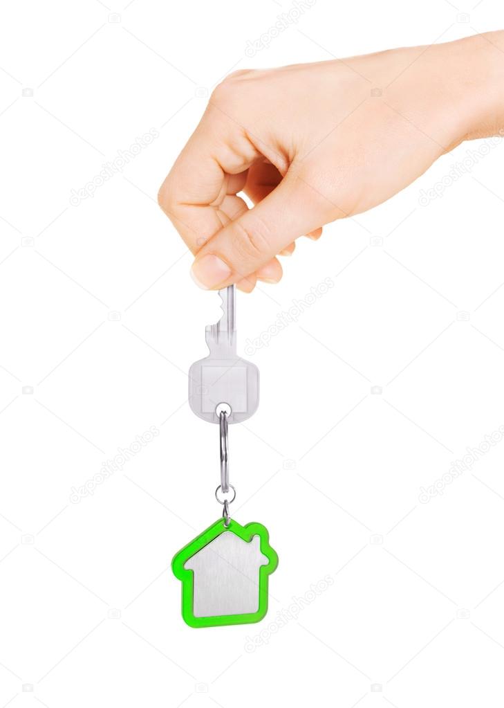 Hand holding key of house