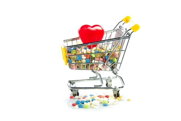 Shopping trolley with pills,heart isolated on white background — Stock Photo, Image