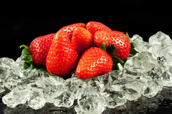 Strawberry on the ice on black background — Stock Photo, Image