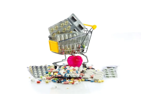 Shopping trolley with pills,heart isolated on white background — Stock Photo, Image