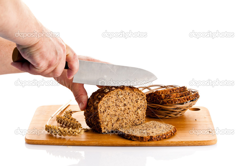 man hand cutting bread isolated on white background