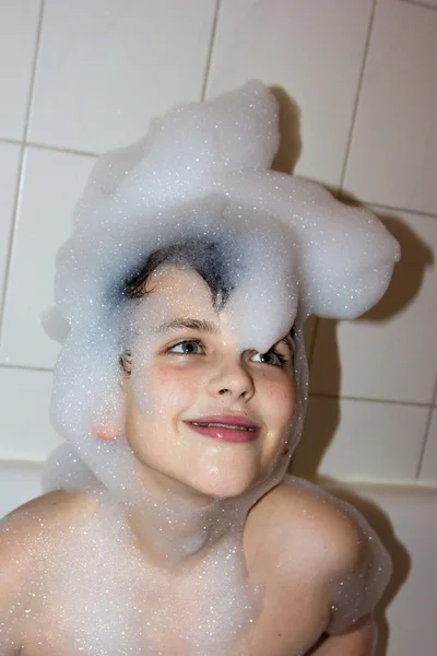 Autistische kind in een GLB van schuim zeep glimlachend creatieve zoon hoed van schuim — Stockfoto