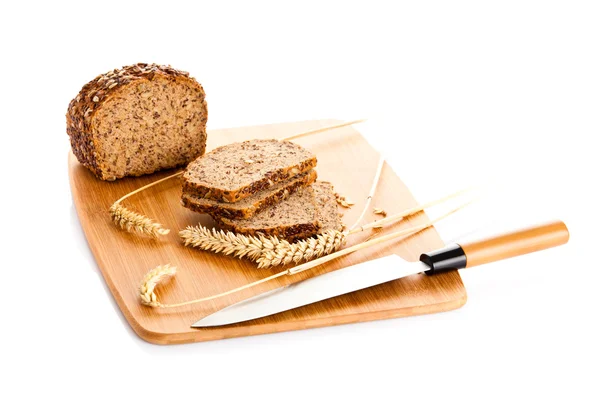 Loaf of wholemeal bread  cutting into slices on wood bread board — Stock Photo, Image