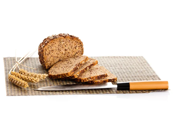 Loaf of wholemeal bread  cutting into slices on wood bread board — Stock Photo, Image