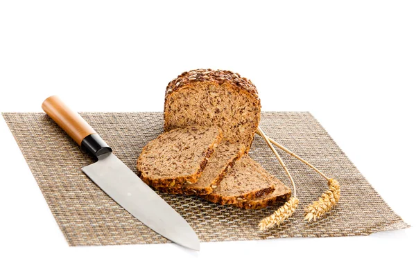 Hoja de pan integral cortada en rodajas sobre tabla de pan de madera — Foto de Stock