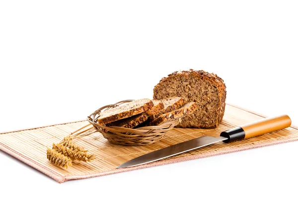 Loaf of wholemeal bread  cutting into slices on wood bread board — Stock Photo, Image