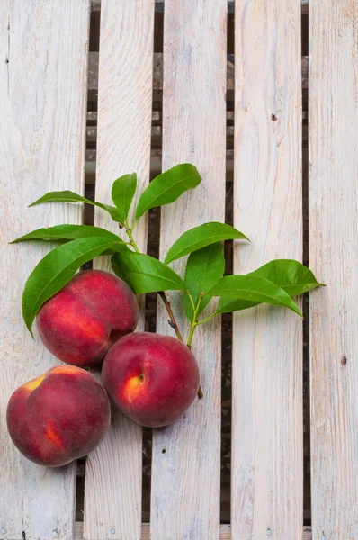 Peaches on wooden background — Stock Photo, Image