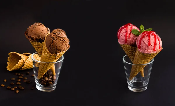 Banner. Closeup on chocolate and strawberry ice cream and in the waffle cone on the black background. Copy space.