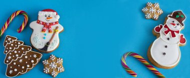 Christmas gingerbread on the blue background. Banner. Copy space.