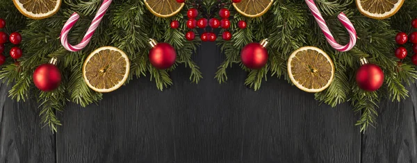 Christmas Banner Spruce Branches Dried Orange Red Bead Black Wooden — Stock Photo, Image