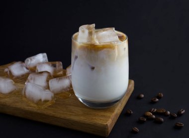 Vietnamese iced coffee in the drinking glass on the black background.Close-up.Copy space.