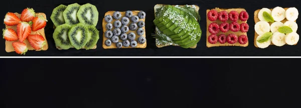 Collage of sandwiches with fruit, berry and vegetable on the black background. Copy space. Top view.