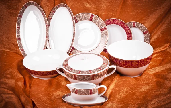 Dinnerware set on orange background — Stock Photo, Image