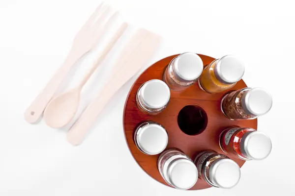 A close up on a spice rack full of a variety of different spices and herb isolated on a white background. — Stock Photo, Image