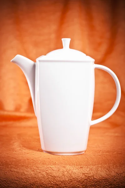 Teapot isolated on orange fabric background — Stock Photo, Image