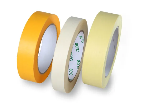 Three rolls of narrow paper tape in white, yellow and brown, iso — Stock Photo, Image