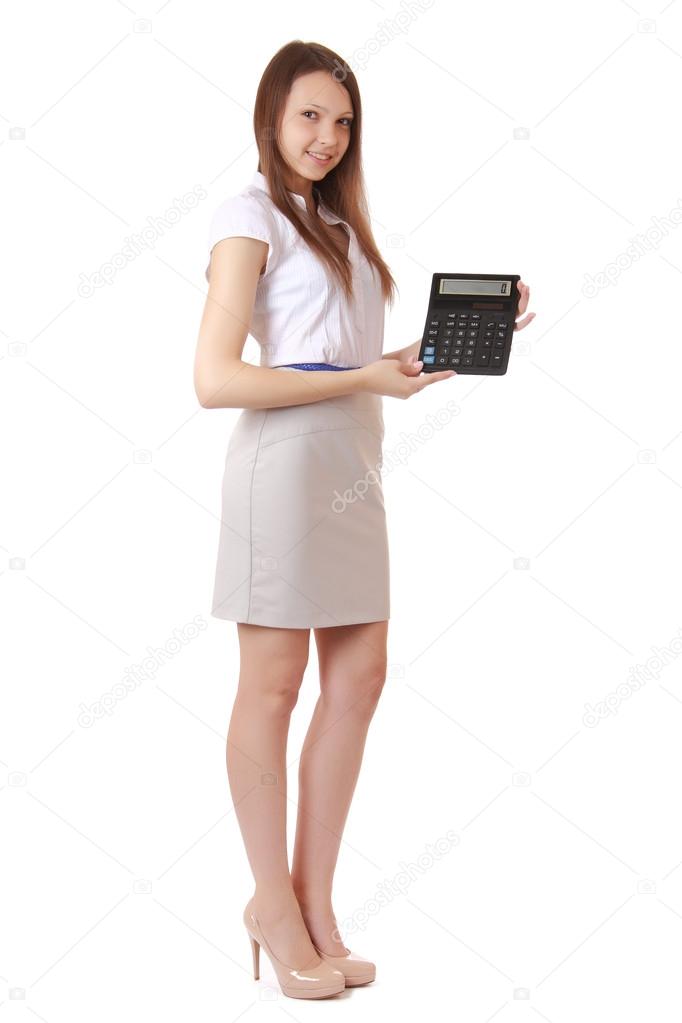 Girl, 16 years old, shows digits on calculator display. Portrait of a girl, full-length auburn hair, a gray skirt, shirt with short sleeves. Isolated image on a white background, vertical orientation.