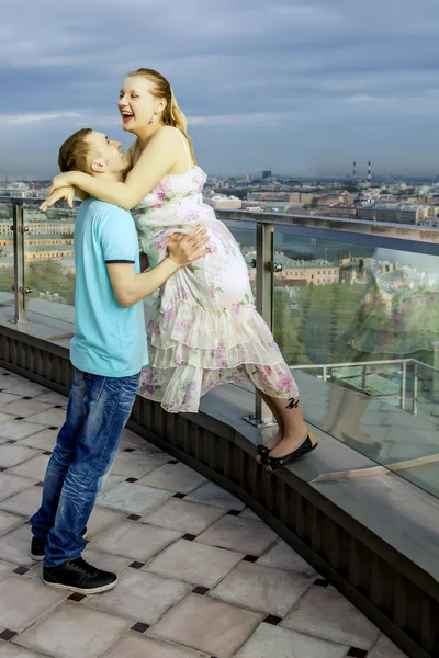Ευτυχισμένο ζευγάρι περπάτημα στην οροφή ενός υψηλού κτιρίου, με θέα — Φωτογραφία Αρχείου