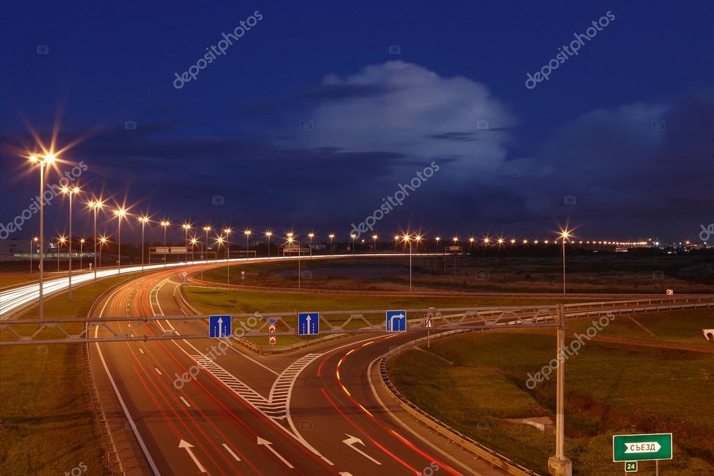 Ringway St Petersburg. Russian road at night, with markings, road signs and lighting masts. The