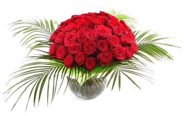 A large bouquet of red roses in a transparent glass vase. The isolated image on a white background.