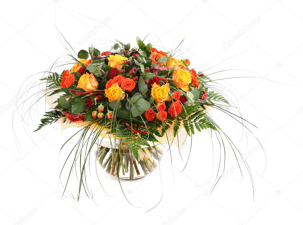Floral composition of orange roses, hypericum and fern. Flower arrangement in a transparent glass vase. Isolated on white.