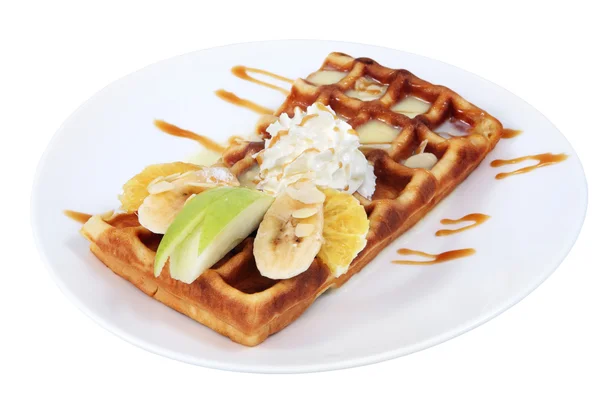 Belgian waffle with condensed milk, whipped cream and fruit. — Stock Photo, Image