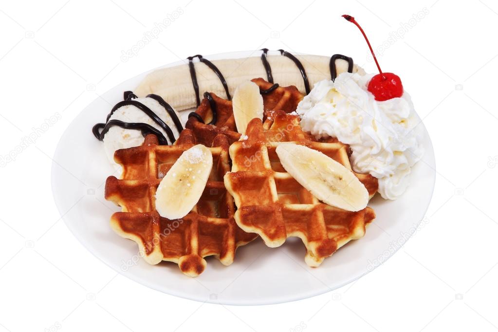 Belgian waffles with whipped cream and scoop of ice cream.