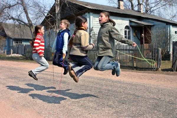 Russian, rural schoolchildren during recess, jumping rope — Stock Photo, Image