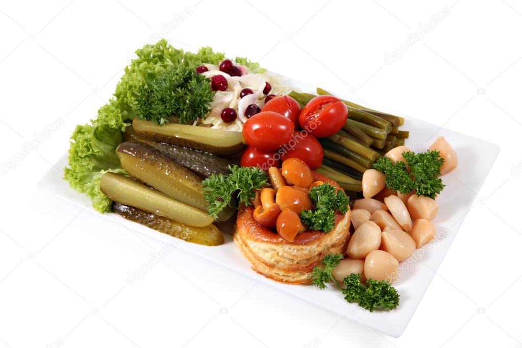  assorted pickled vegetables on the plate, isolated over  white 