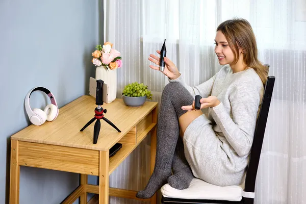 Tabletop tripod with smartphone holder is used by female vlogger for streaming. — Stock Photo, Image