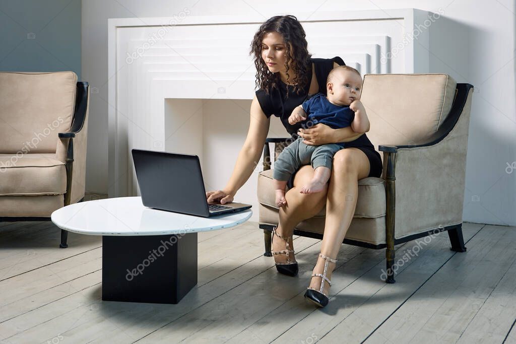 Woman in maternity leave works remotely, with child on his knees.