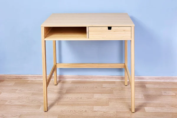 Console table with storage or writing desk against light blue wall in lounge room. — Stock Photo, Image