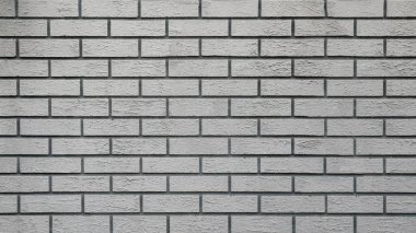 Duvardaki duvar kağıdı dekoratif tuğla işi şeklinde.