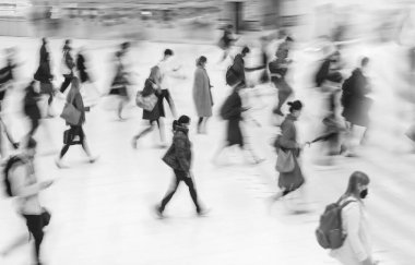 Blur of focus, people walk up the stairs in the lobby of a public building